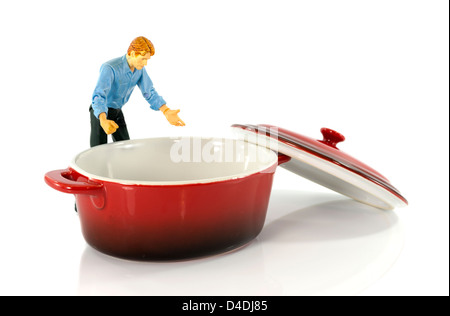 model man looking in red empty saucepan Stock Photo