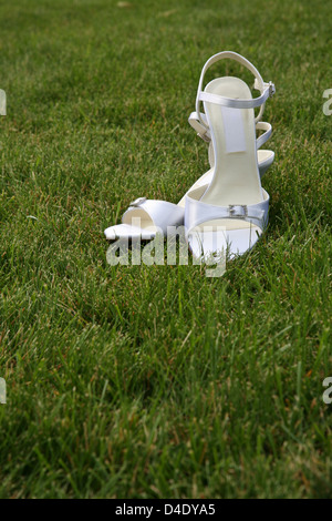 Wedding bridal shoes on green grass Stock Photo