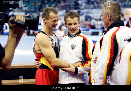 (L-R) Germany's Robert Juckel , Fabian Hambuechen and his father Wolfgang Hambuechen celebrate winning the silver medals in the team finals of the 28th European Men's Artistic Gymnastics Championships in Lausanne, Switzerland, 10 May 2008. Photo: FRANK MAY Stock Photo