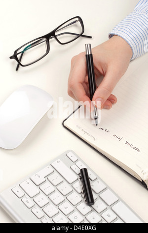 Woman's hand with pen Stock Photo