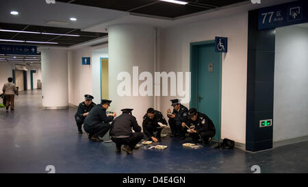 Policemen having dinner before a football match in the stadium of the Nanjing Olympic Sports Center. Stock Photo