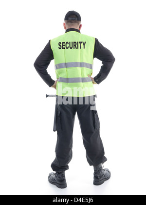 Security man wearing black uniform and yellow reflective vest standing confidently with arms resting on hips, facing back Stock Photo