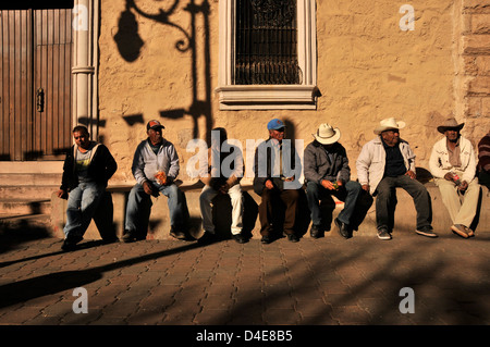 Men sit at a plaza in Nogales, Sonora, Mexico, across the border from Nogales, Arizona, USA. Stock Photo