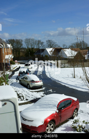 Snow ridden road, cars houses march 2013 snow hastings snowy landscape Stock Photo