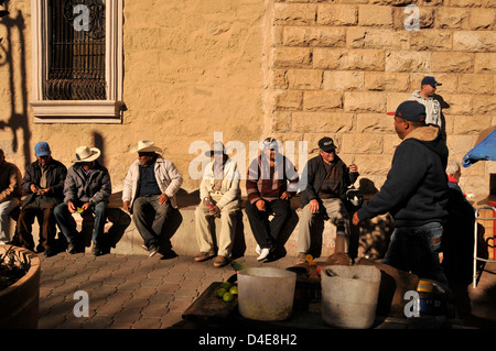 Men sit at a plaza in Nogales, Sonora, Mexico, across the border from Nogales, Arizona, USA. Stock Photo