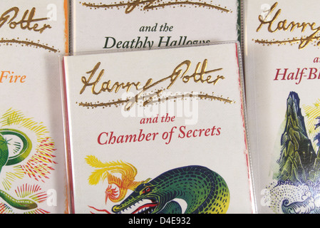 The book cover of 'Harry Potter and the Chamber of Secrets' by JK Rowling sitting on other books in the series. Stock Photo