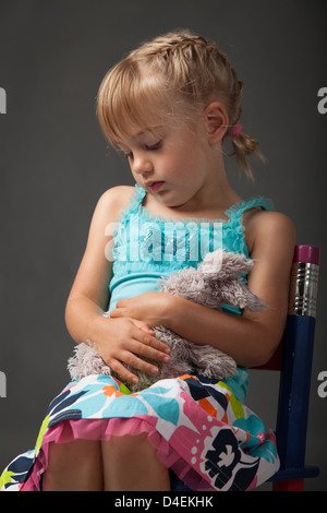 Little girl cuddling her favourite soft toy Stock Photo