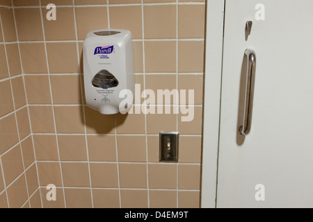 Hand sanitizer on public restroom wall - USA Stock Photo