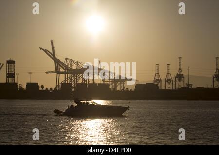 Long Beach, California, USA. 12th March 2013. The dark silhouette of the machinery and cranes of the container terminal stand against the backdrop of a sunset evening sky at the Long Beach Port , California on March 12, 2013. (Credit Image: Credit:  Ringo Chiu/ZUMAPRESS.com/Alamy Live News) Stock Photo