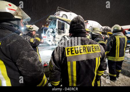Fire fighters work at the A45 motorway after a multiple collision involving more than 100 cars and lorreys near Woelfersheim, Germany, 12 March 2013. Serveral people were sverely injured and the motorway was fully closed off. Photo: Boris Roessler Stock Photo