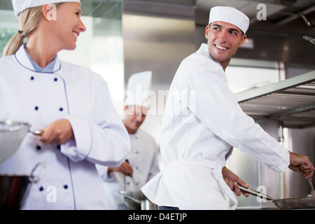 Chefs talking in restaurant kitchen Stock Photo