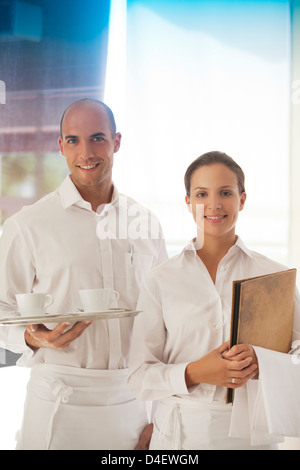 Wait staff smiling in restaurant Stock Photo