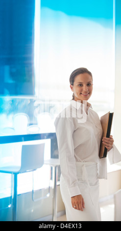 Waitress smiling in restaurant Stock Photo