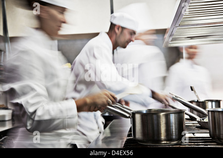 Chefs cooking in restaurant kitchen Stock Photo