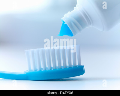 Close up of toothpaste squeezing on toothbrush Stock Photo