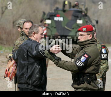 Soldiers of German Bundeswehr and Austrian Military Police inspect a driver during a street checkup north of Mitrovica, Kosovo, 04 April 2008. Photo: Matthias Schrader Stock Photo