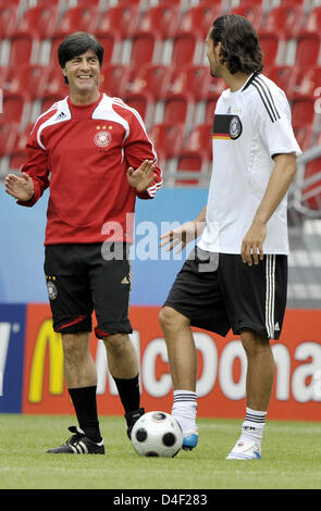 German national soccer coach Joachim Loew (L) and team's player Kevin Kuranyi joke during the training session in Klagenfurt, Austria, 07June 2008. Germany will play against Poland in their first Euro 2008 Group B match in Klagenfurt, Austria on 08 June 2008. Photo: Achim Scheidemann dpa +please note UEFA restrictions particularly in regard to slide shows and +'No Mobile Services'+ Stock Photo