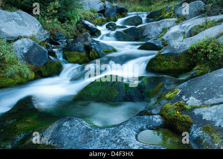 Time lapse view of water rushing over rocks Stock Photo