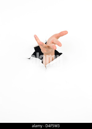 close-up of female hand coming out from a hole in a paper, with a gesture of offering something, isolated on white Stock Photo