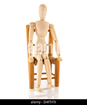 wooden puppet sitting on chair isolated on white background Stock Photo