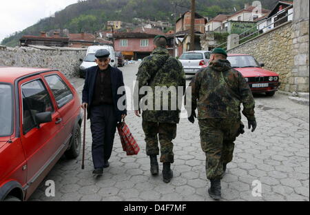 Two soldiers of German Bundeswehr patrol the destroyed and still closed ...
