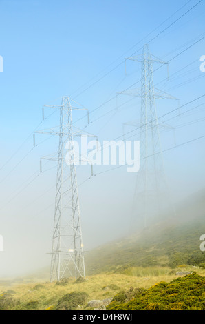 Pylons in mist at Bwlch y Ddeufaen in the Carneddau Snowdonia North Wales Stock Photo