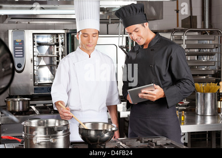 Chefs Preparing Food In Kitchen Stock Photo