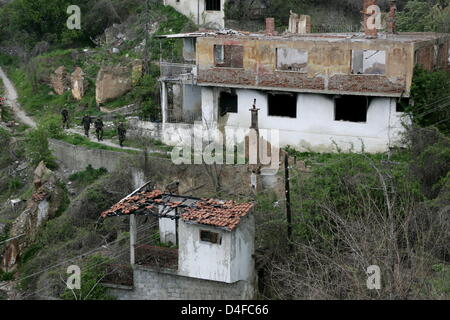 Soldiers of German Bundeswehr patrol the destroyed and still closed ...