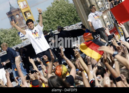 The captain of Germany's national soccer team, Michael Ballack, celebrates on stage during the team reception on the streets in front of Brandenburg Gate in Berlin, Germany, 30 June 2008. Germany's national soccer team was received by hundreds of thousands fans at Brandenburg Gate after arriving at Berlin-Tegel airport. The team had lost the Euro2008 final against Spain 0-1. Photo: Stock Photo