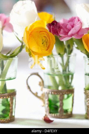 Close up of flower bunches in glasses Stock Photo