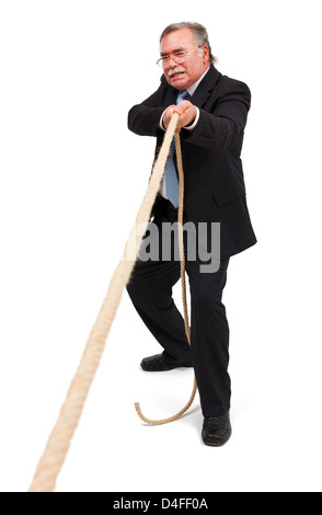 Tug of war game; senior business man pulling hard, alone a rope Stock Photo