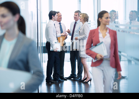 Business people talking in office hallway Stock Photo