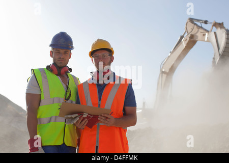 Workers standing in quarry Stock Photo