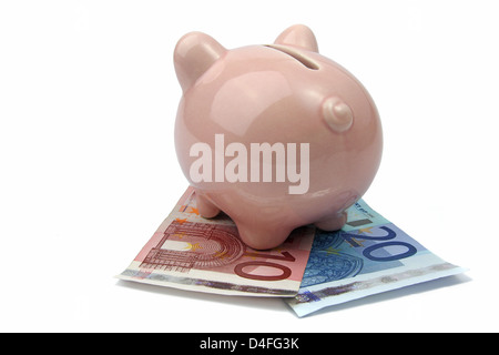 pig bank from back side on euro banknotes Stock Photo