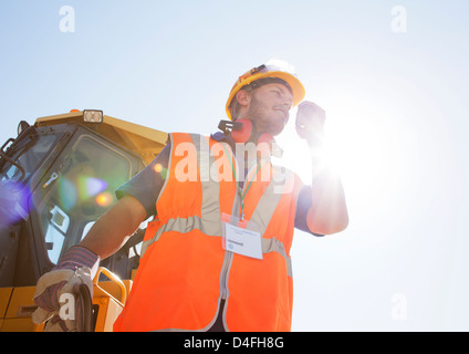 Worker using walkie-talkie on site Stock Photo