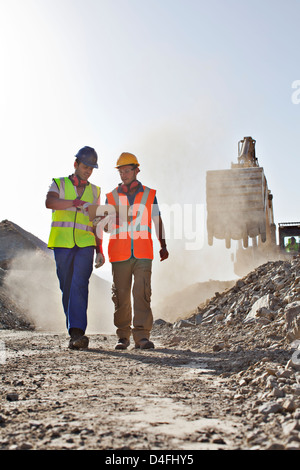 Workers talking in quarry Stock Photo