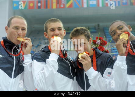 US swimmers Cullen Jones (L-R), Jason Lezak, Michael Phelps and Garrett Weber-Gale pose with their gold medals after swimming to world record victory in the team men's 4 X 100m freestyle relay during the 2008 Beijing Olympics at the National Aquatics Center in Beijing, China, 11 August 2008. The US team won world record gold of 3:08.24. Photo: Bernd Thissen (c) dpa - Bildfunk Stock Photo