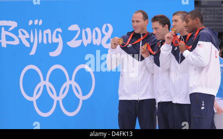 US swimmers Cullen Jones (L-R), Jason Lezak, Michael Phelps and Garrett Weber-Gale pose with their gold medals after swimming to world record victory in the team men's 4 X 100m freestyle relay during the 2008 Beijing Olympics at the National Aquatics Center in Beijing, China, 11 August 2008. The US team won world record gold of 3:08.24. Photo: Bernd Thissen (c) dpa - Bildfunk Stock Photo