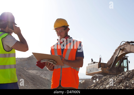 Workers standing in quarry Stock Photo