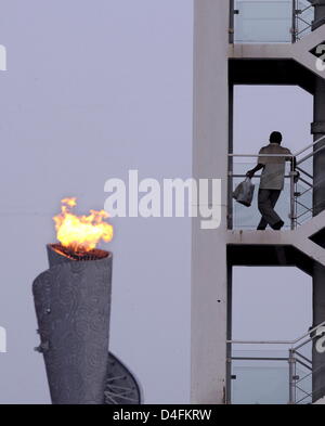 The olympic flame seen behind a staircase of the Ling Long Broadcasting Tower near the National Stadium in Beijing, China, 12 August 2008. Photo: Karl-Josef Hidenbrand dpa ###dpa### Stock Photo