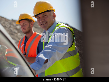 Businessman smiling in quarry Stock Photo