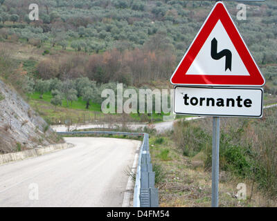 (dpa file)- A traffic sign with the Italian word 'tornante' on it, seen in Italy, 28 February 2008, warns drivers that a winding road lies ahead. Photo: Lars Halbauer Stock Photo