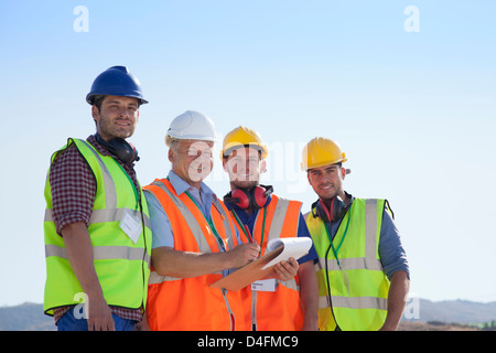 Businessman and workers smiling on site Stock Photo