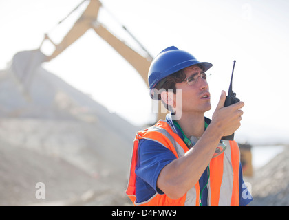 Worker using walkie-talkie in quarry Stock Photo