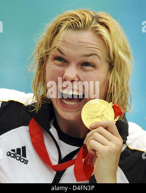 Firstplaced Britta Steffen from Germany (L) celebrates her goldmedal after she placed first in the swimming women's 100m freestyle final at the Beijing 2008 Olympic Games in Beijing China, 15 August 2008. Steffen won in a time of 53.12 seconds and set up a new olympic record. Photo: Peer Grimm Stock Photo