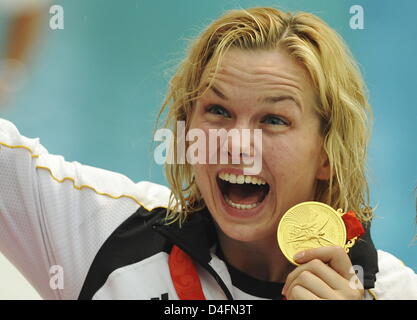 Firstplaced Britta Steffen from Germany (L) celebrates her goldmedal after she placed first in the swimming women's 100m freestyle final at the Beijing 2008 Olympic Games in Beijing China, 15 August 2008. Steffen won in a time of 53.12 seconds and set up a new olympic record. Photo: Peer Grimm Stock Photo