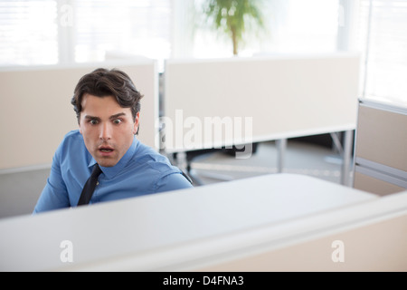 Surprised businessman working in office Stock Photo