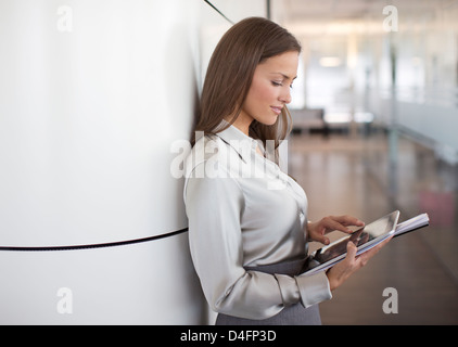 Businesswoman using digital tablet in office Stock Photo