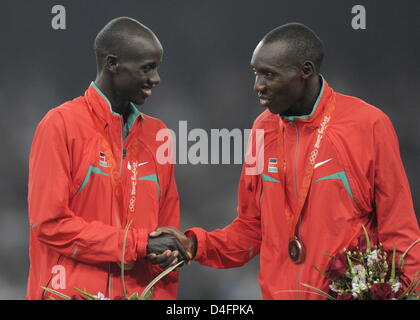 Gold winner Brimin Kiprop Kirpruto (L) congratulates bronze winner Richard Kipkemboi Mateelong, both from Kenya, during the medal ceremony for the Men's 3000m Steeplechase Final during the Beijing 2008 Olympic Games in Beijing, China, 18 August 2008. EPA/BERND THISSEN ###dpa### Stock Photo