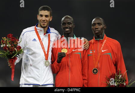 Gold winner Brimin Kiprop Kirpruto (C) from Kenya, silver medalist Mahiedine Mekhissi-B. (L) from France and bronze winner Richard Kipkemboi Mateelong, also from Kenya, celebrate with their medals during the medal ceremony for the Men's 3000m Steeplechase Final during the Beijing 2008 Olympic Games in Beijing, China, 18 August 2008. EPA/BERND THISSEN ###dpa### Stock Photo